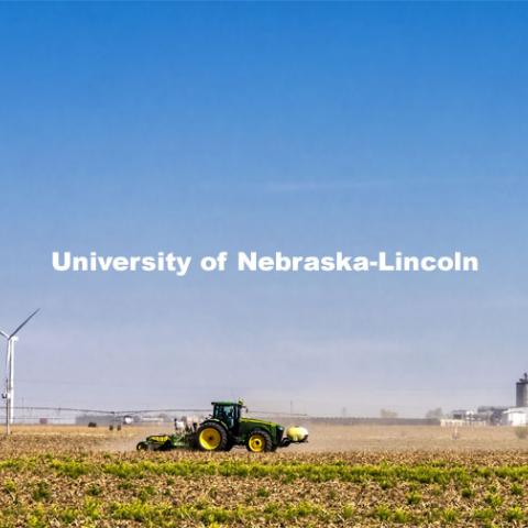 Planting south of Fairmont, Nebraska, with renewable energy in the background. Wind turbines and the Flint Hills Resources ethanol plant. Rural Nebraska. May 1, 2021. Photo by Craig Chandler / University Communication.  